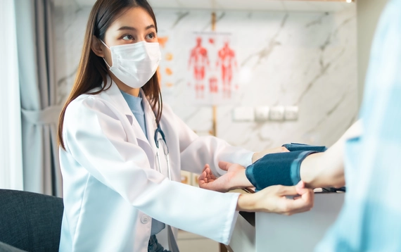 Nurse checking patient's pulse.